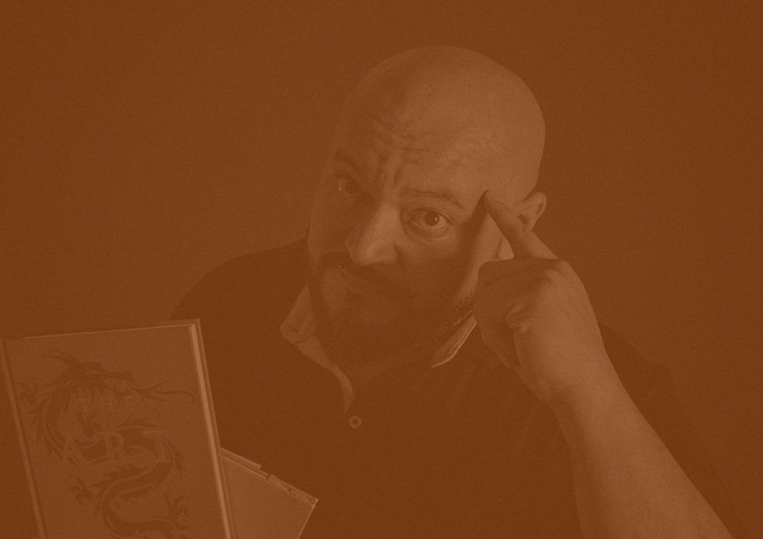 Photo of Diego holding some books of wisdom and signaling the need to learn