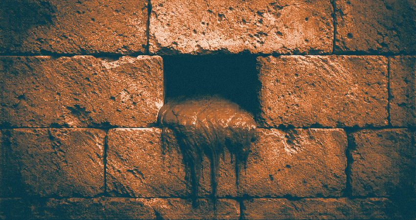 A structure built of limestones with concrete board in the center of a missing block